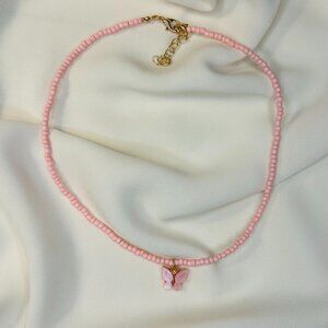 Pink beaded necklace with a butterfly charm!